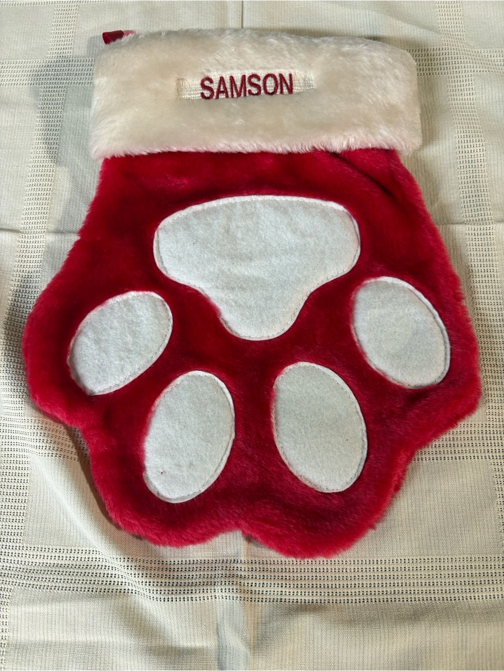 Paw stocking with white cuff embroidered with name 'SAMSON'.